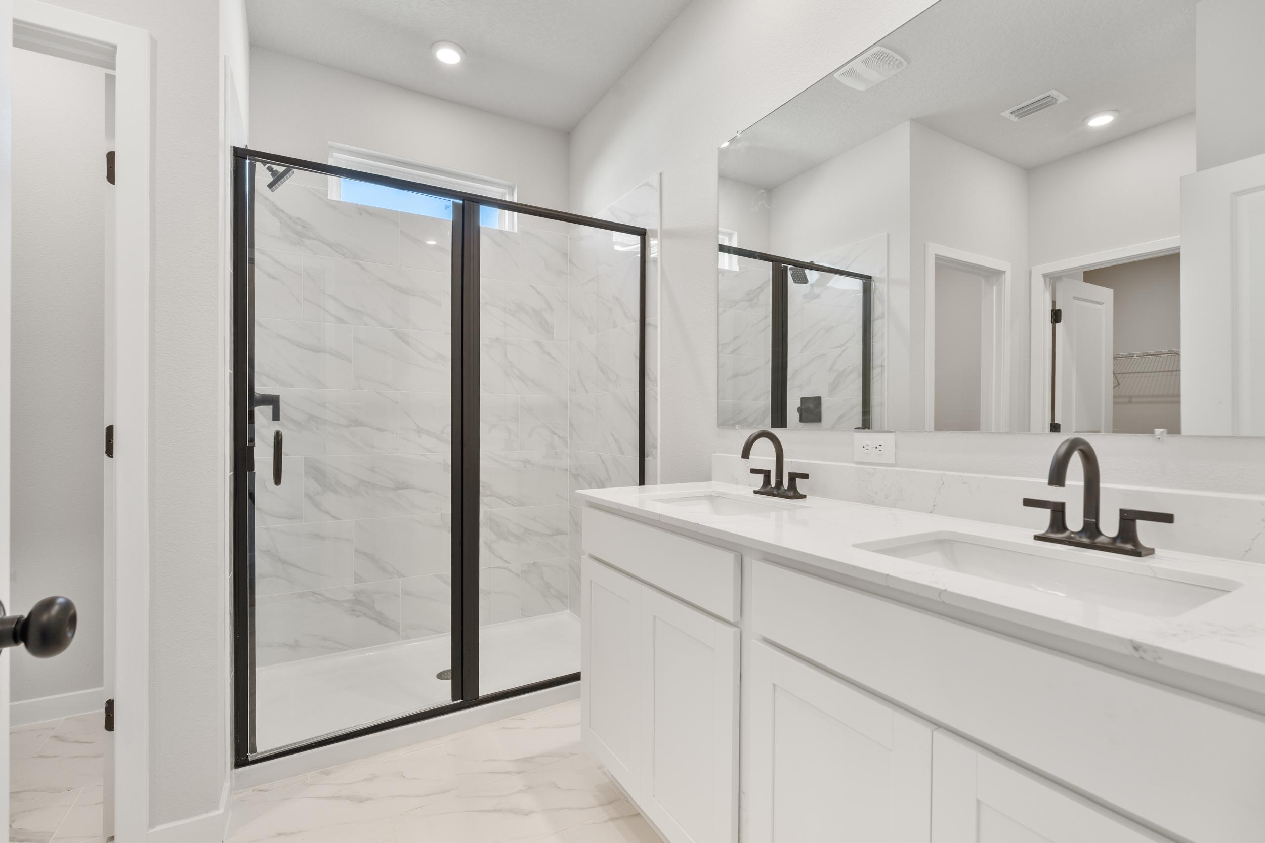 Lot 65 Primary Bathroom with Dual Sinks and Shower at Seminole Palms