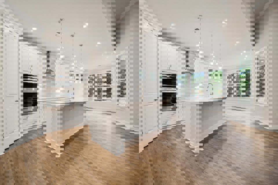 A kitchen with white cabinets.