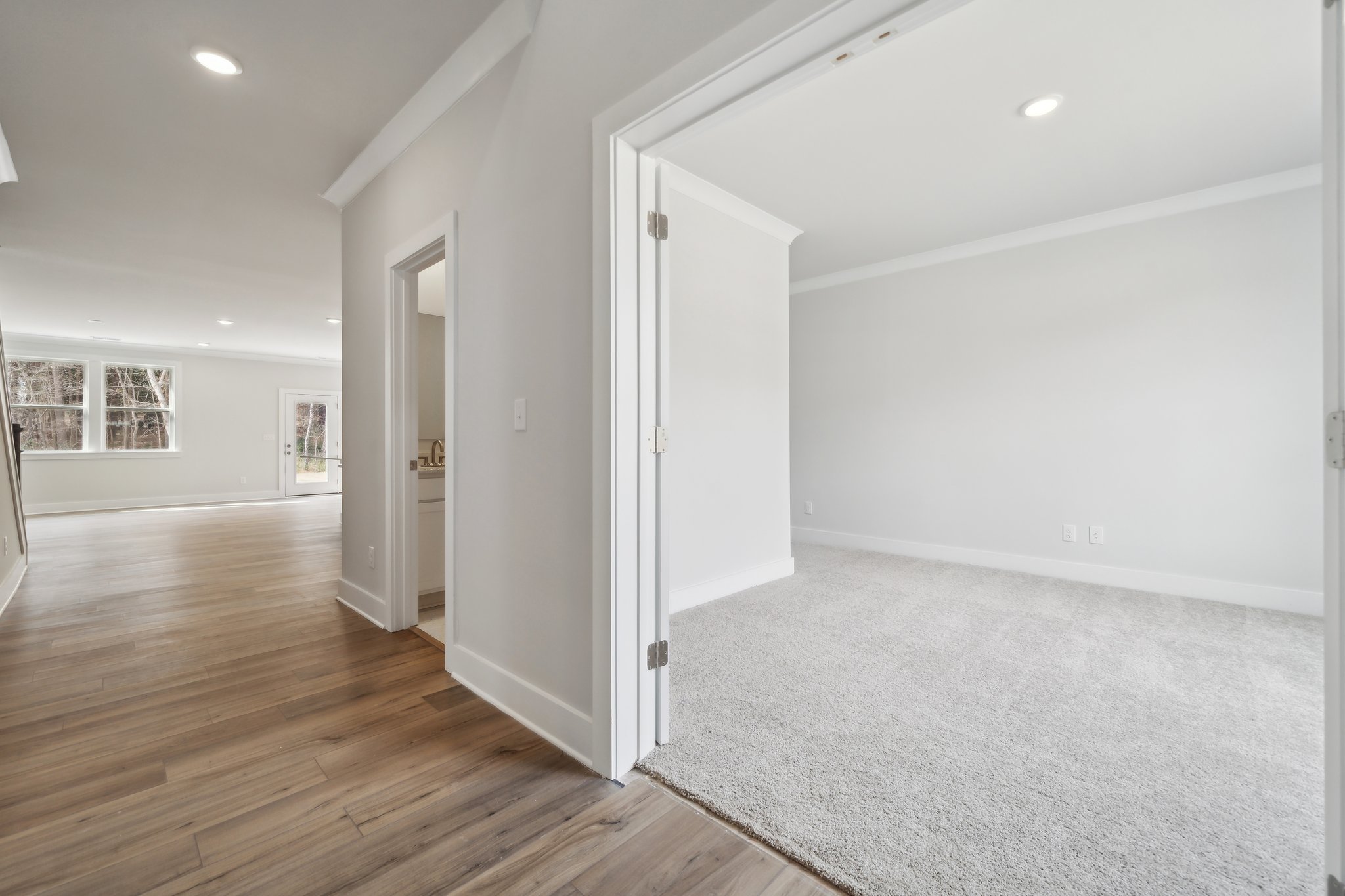 A room with a wood floor and white walls.