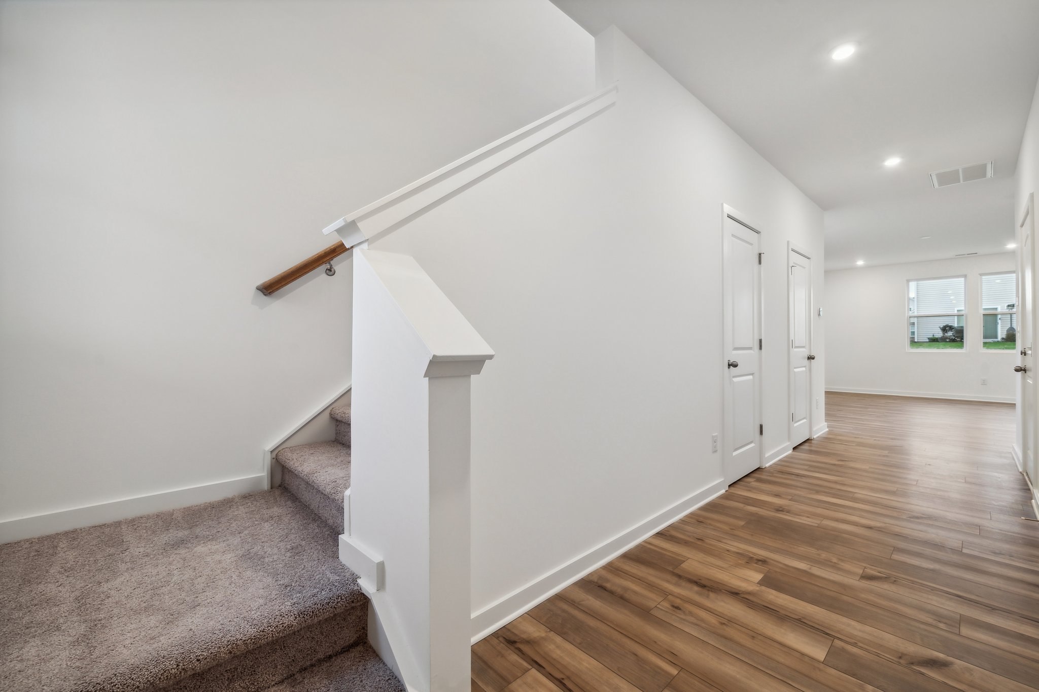 A white staircase in a room.