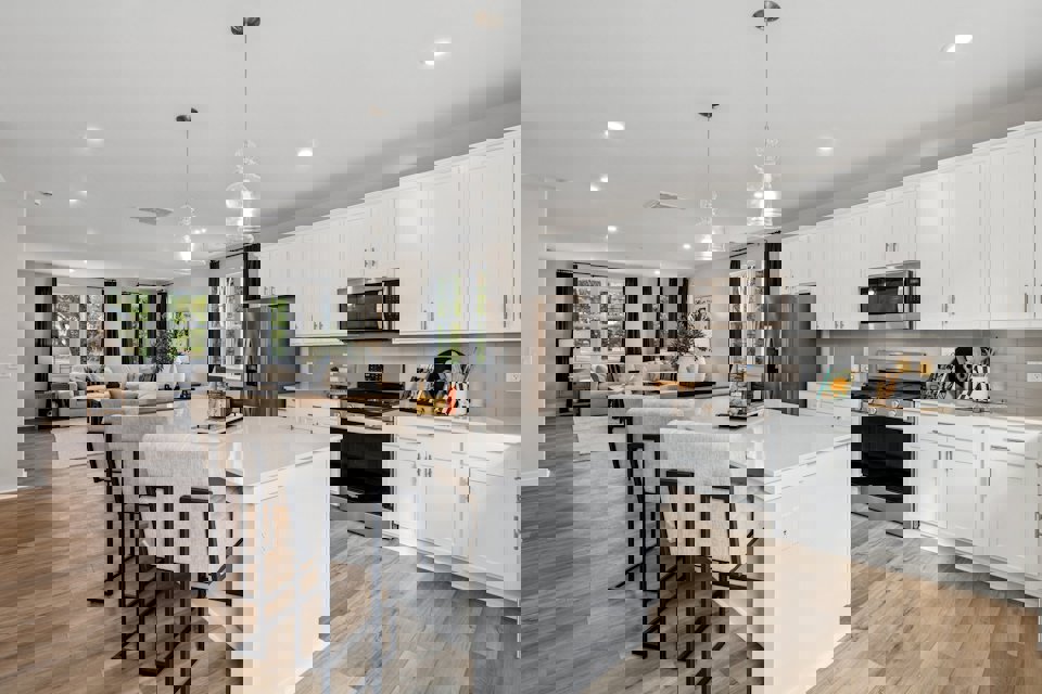 A kitchen with white cabinets.