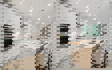 A kitchen with white cabinets.