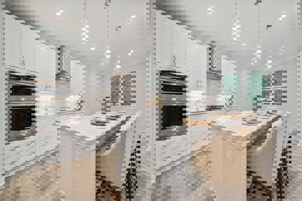 A kitchen with white cabinets.