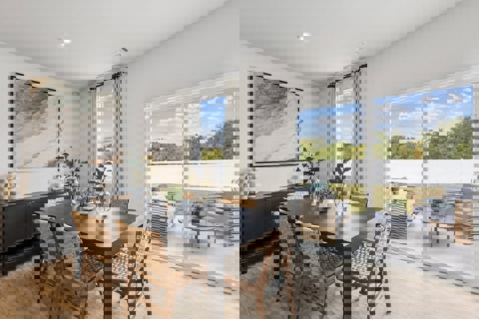 A dining room with a large window.