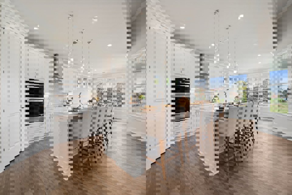 A kitchen with a dining table and chairs.