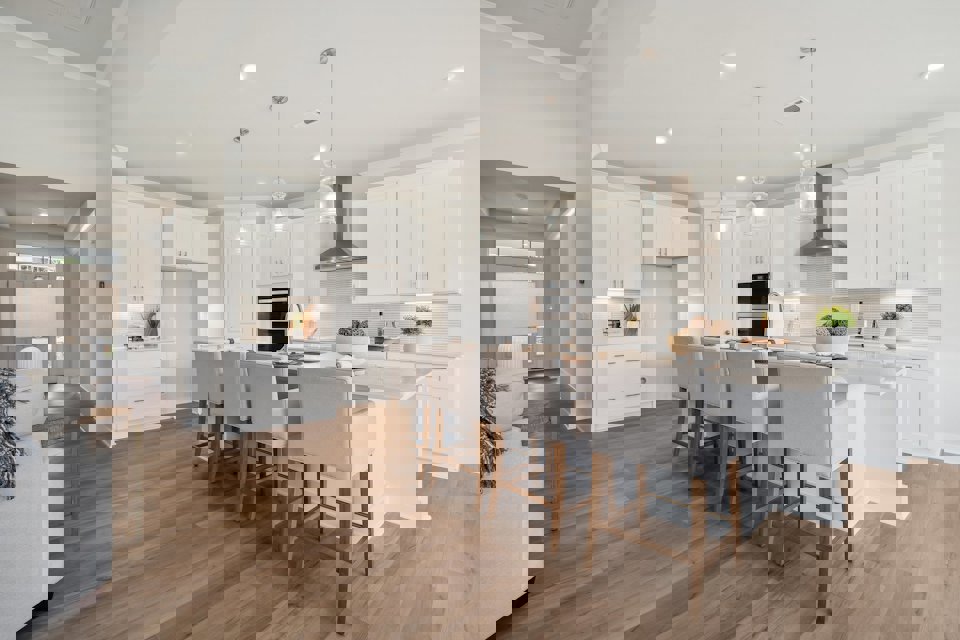 A kitchen with white cabinets.