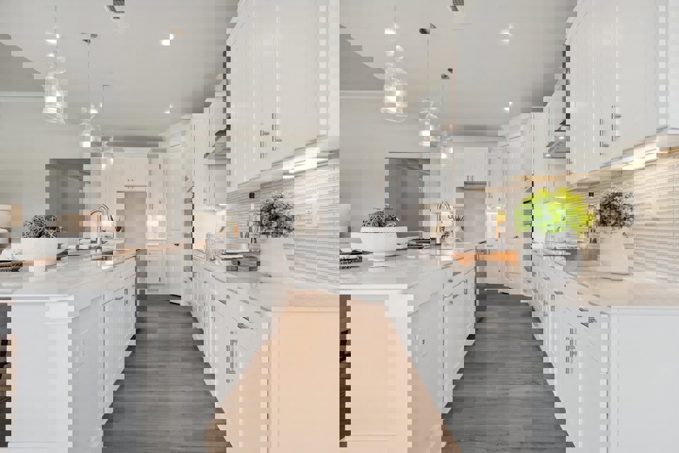 A kitchen with white cabinets.