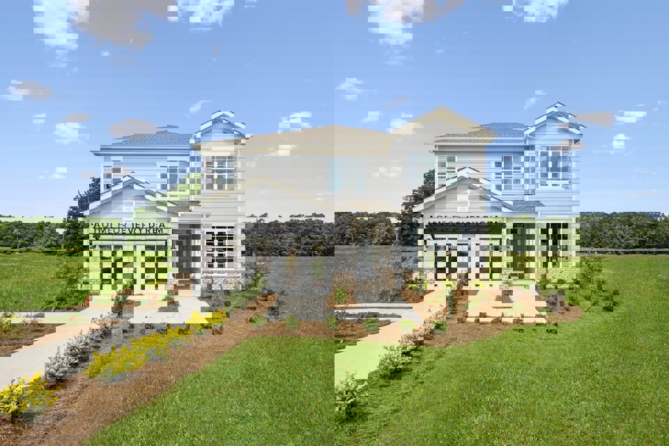 A white house with a lawn.