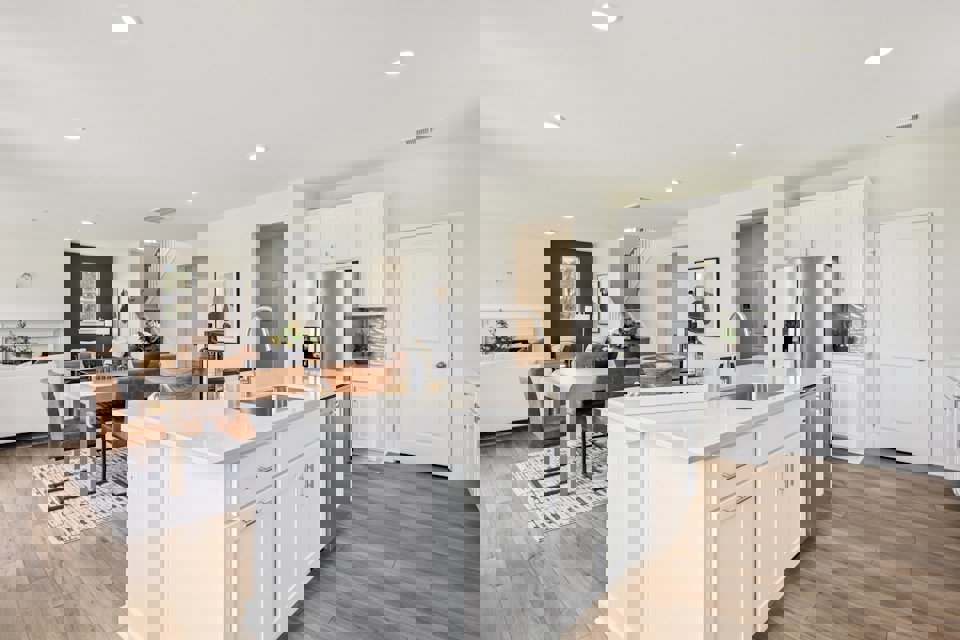 A kitchen with white cabinets.