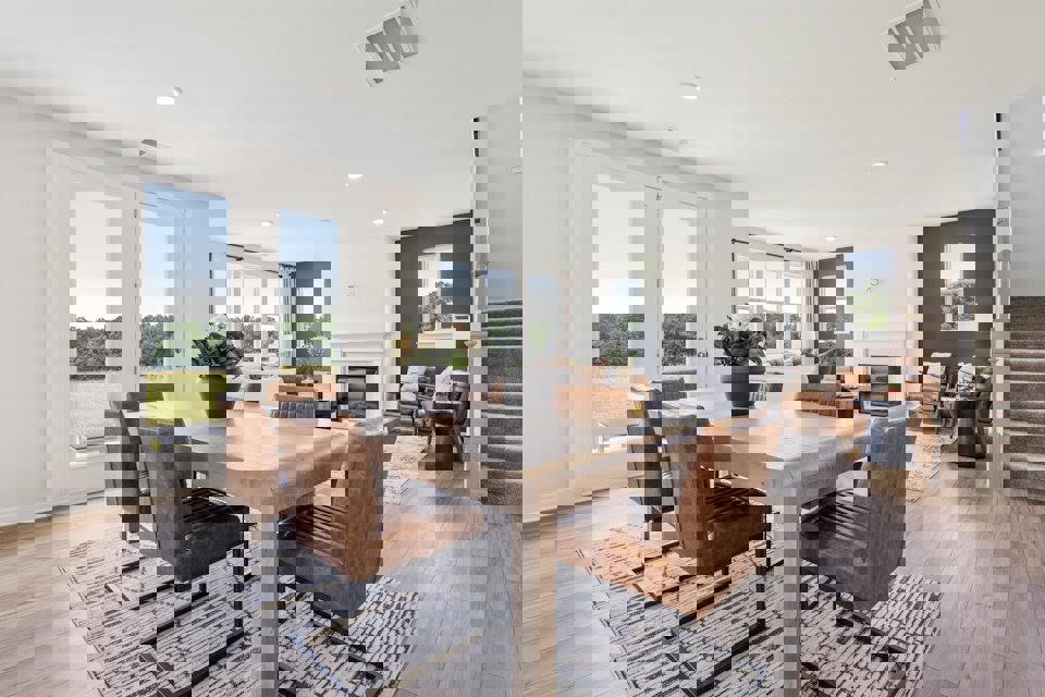 A dining room with a large table.