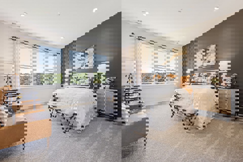 A bedroom with a bed and a table.