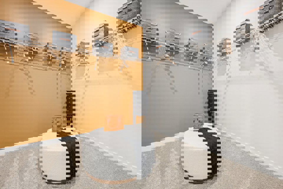 A room with a bed and a chair.