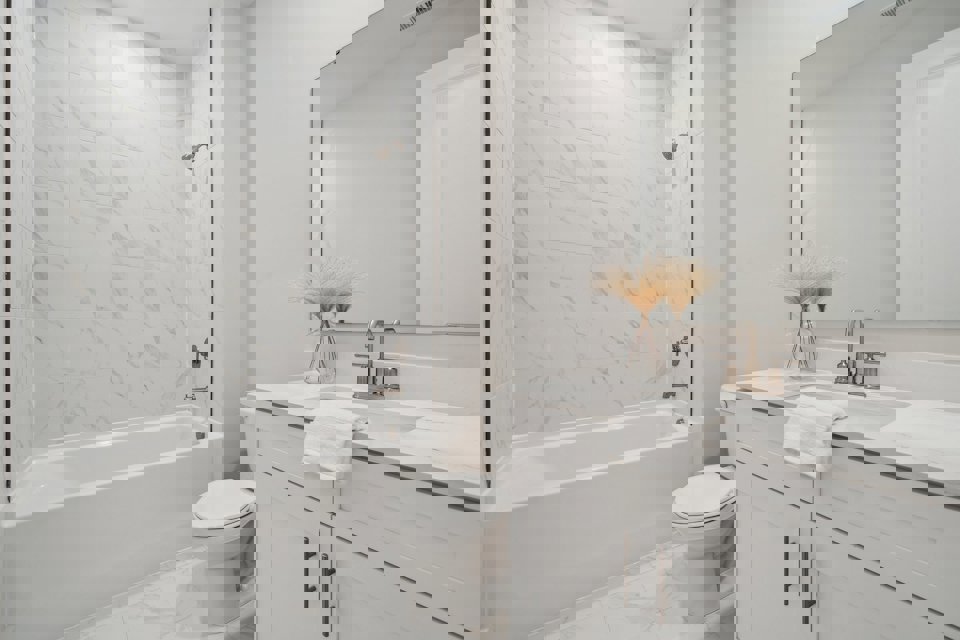 A bathroom with a tub sink and toilet.