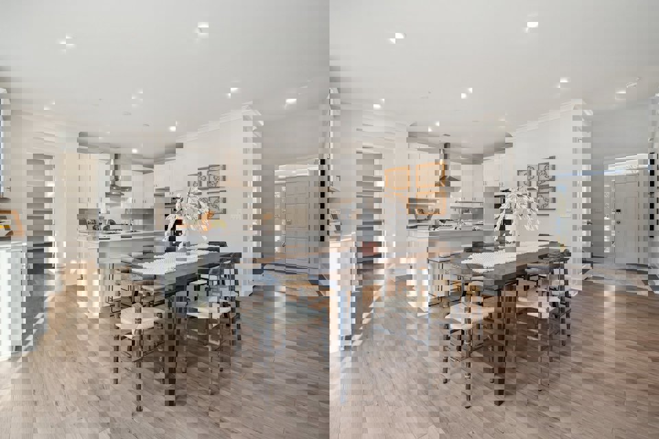 A kitchen with a dining table and chairs.