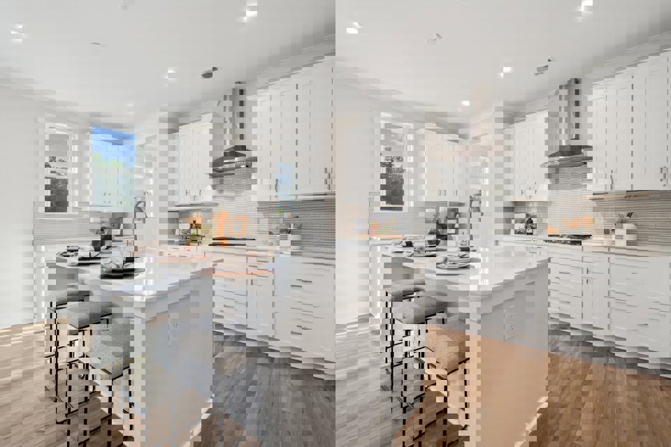 A kitchen with white cabinets.