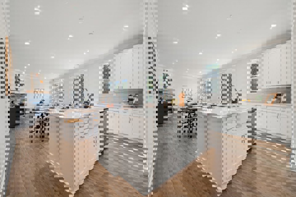 A kitchen with white cabinets.