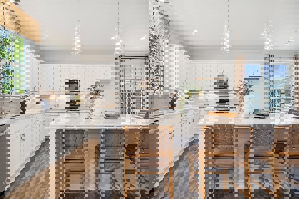 A kitchen with a table and chairs.