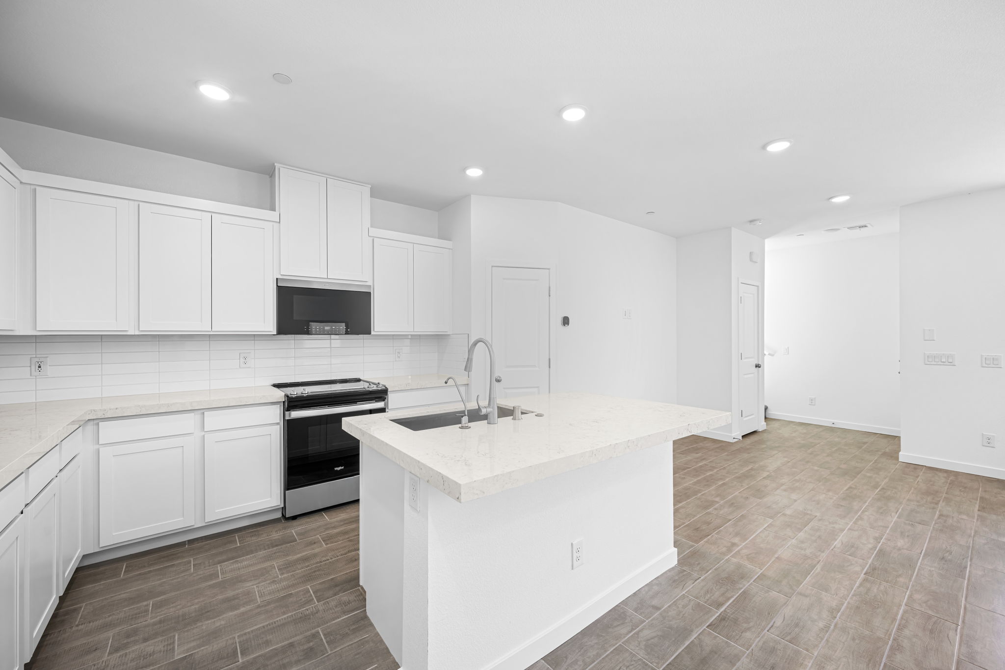 A kitchen with white cabinets.