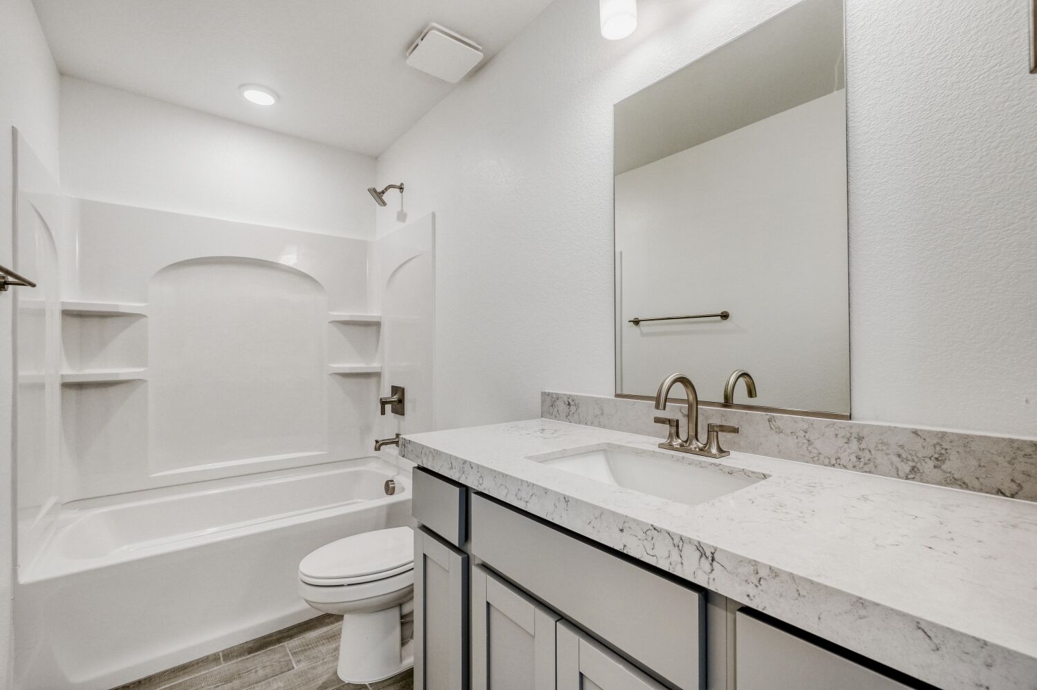 A bathroom with a tub sink and toilet.