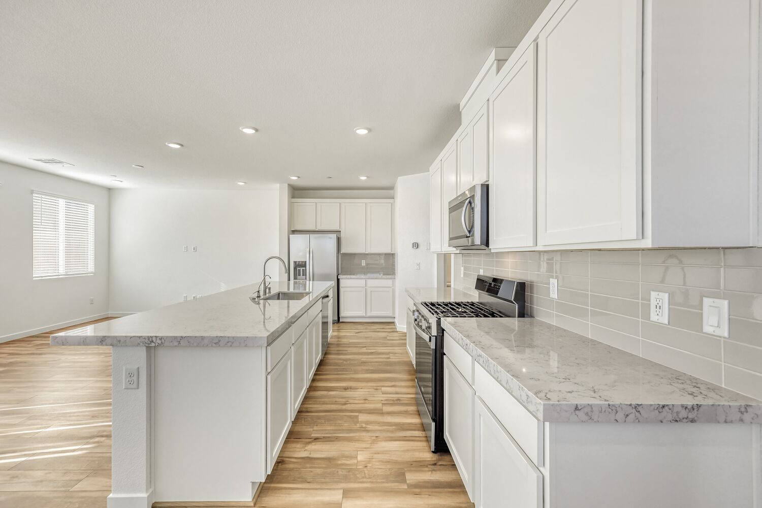 A kitchen with white cabinets.
