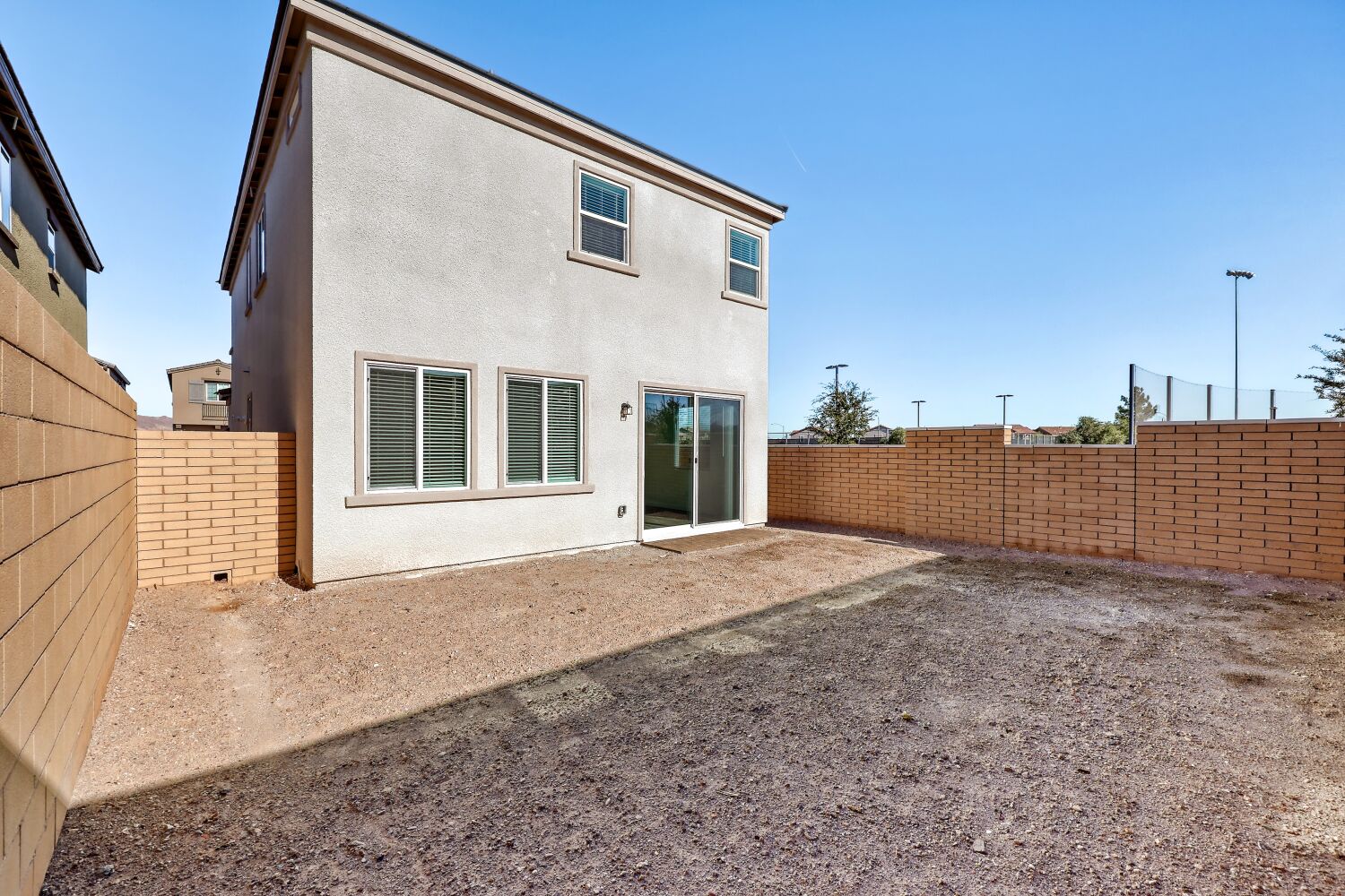A building with a dirt yard.
