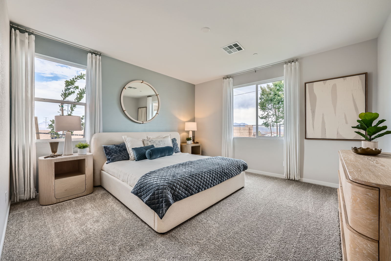 A bedroom with a large window.