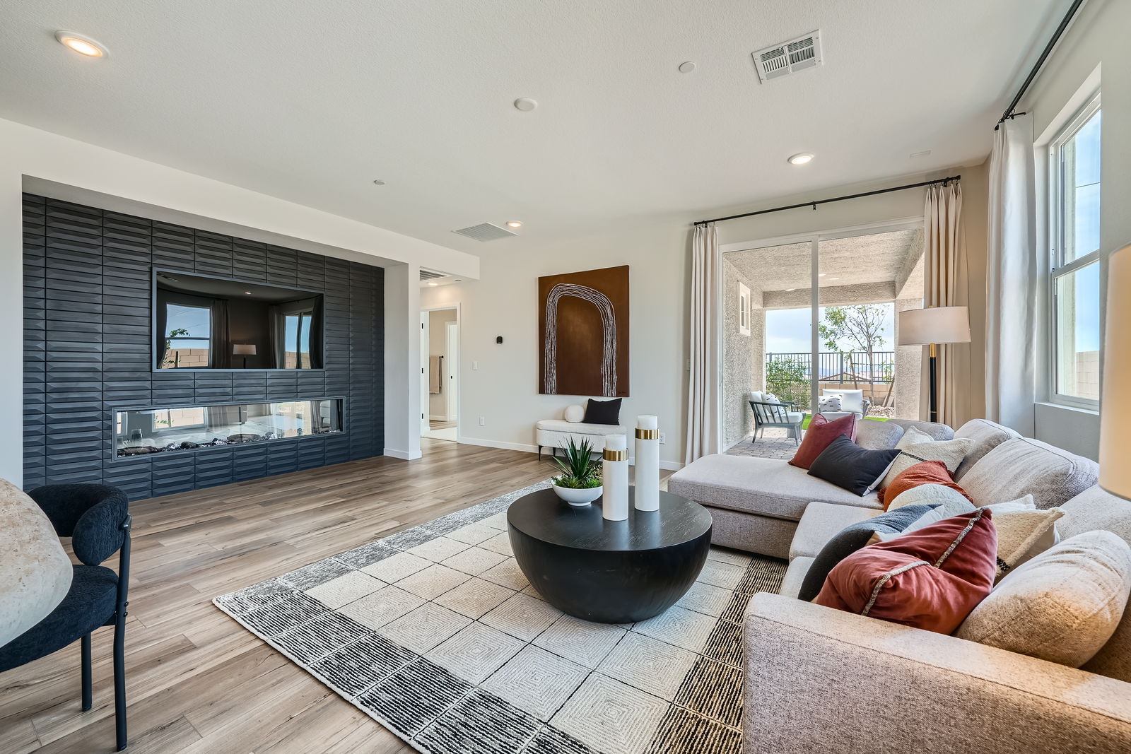A living room with a large rug.