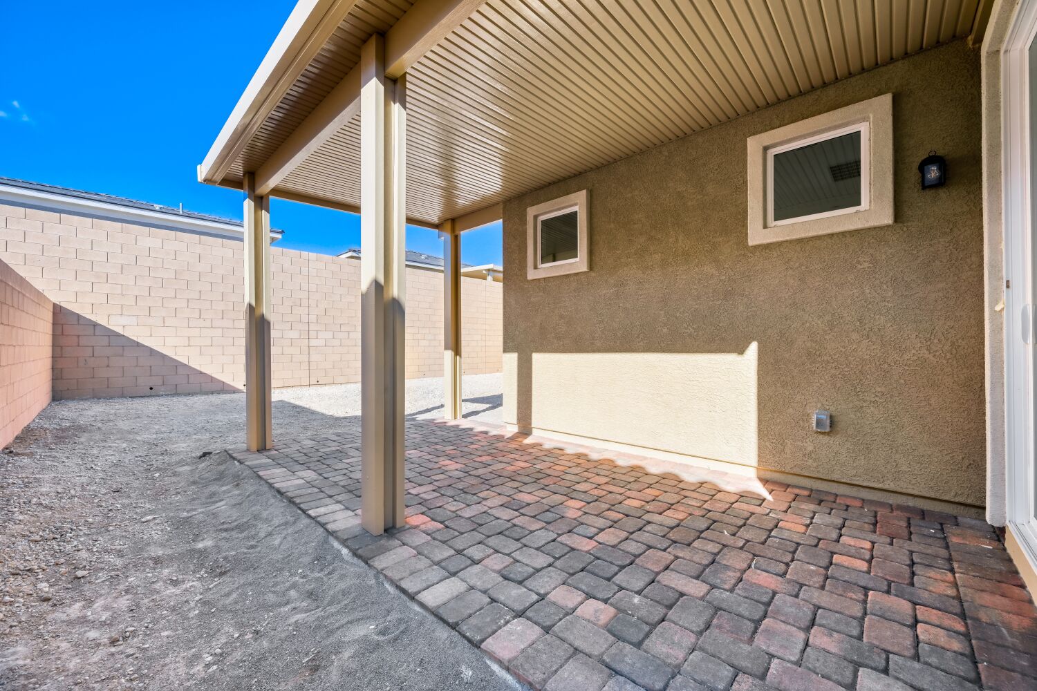 A brick patio with a covered patio.