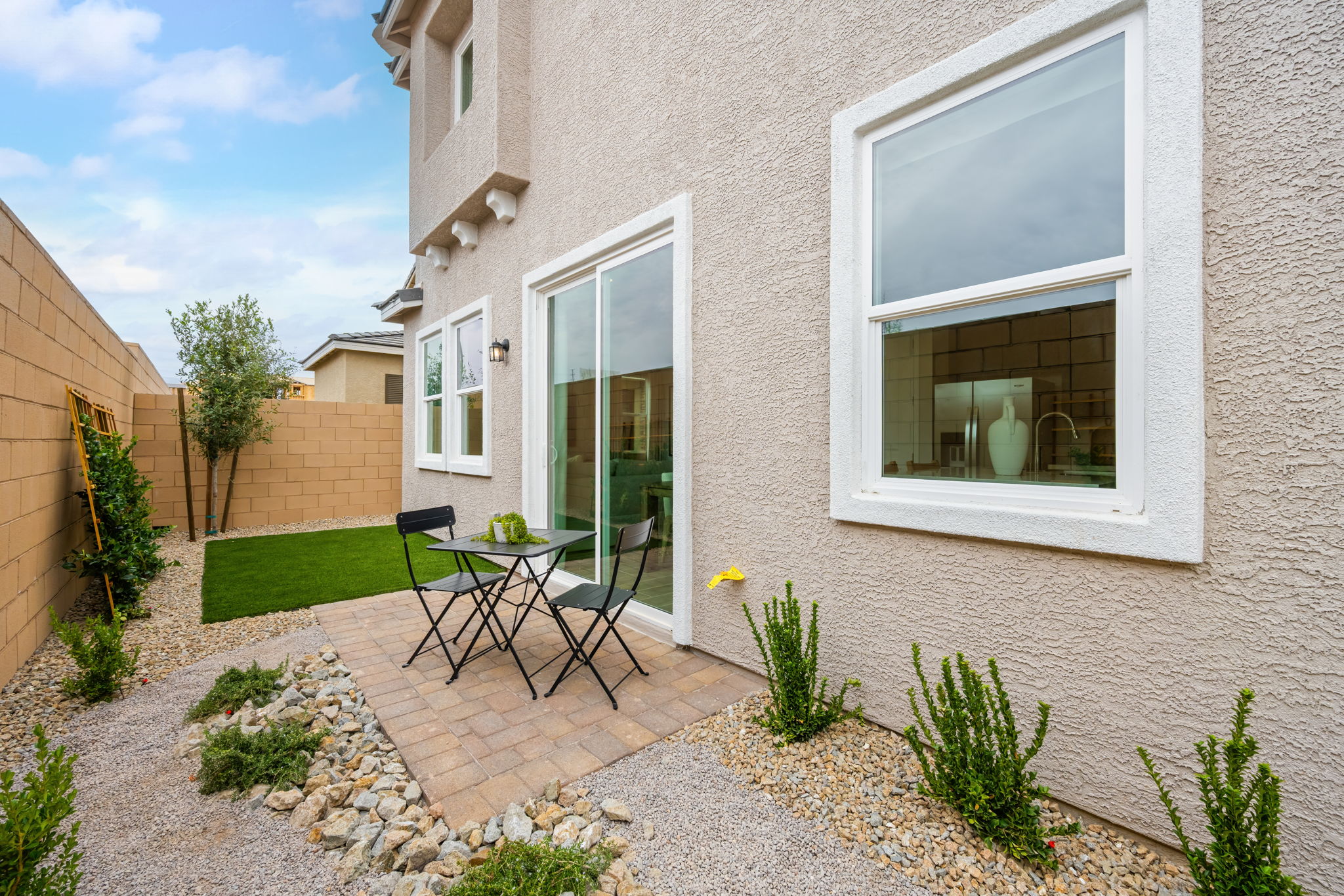 A patio with a table and chairs.