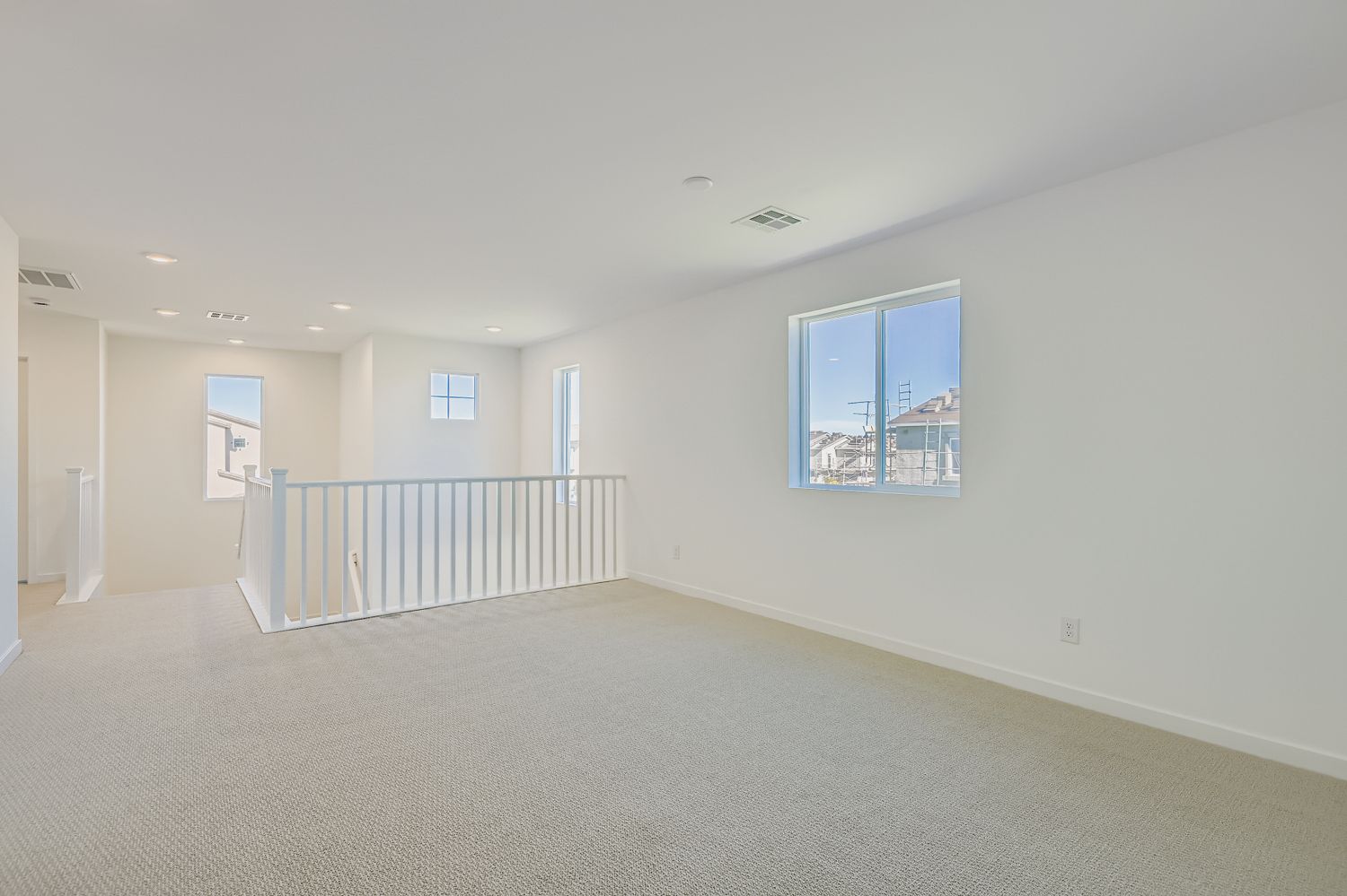 A large empty room with a railing.