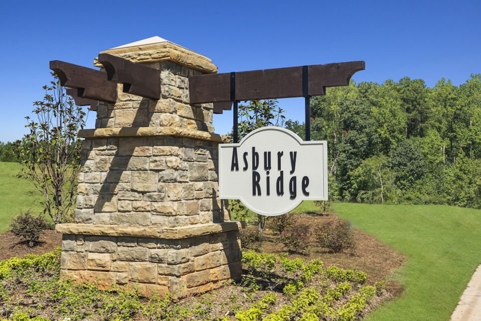 A sign in front of a stone structure.