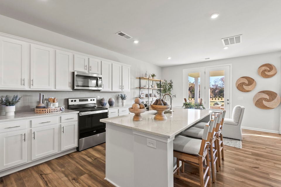 A kitchen with white cabinets.