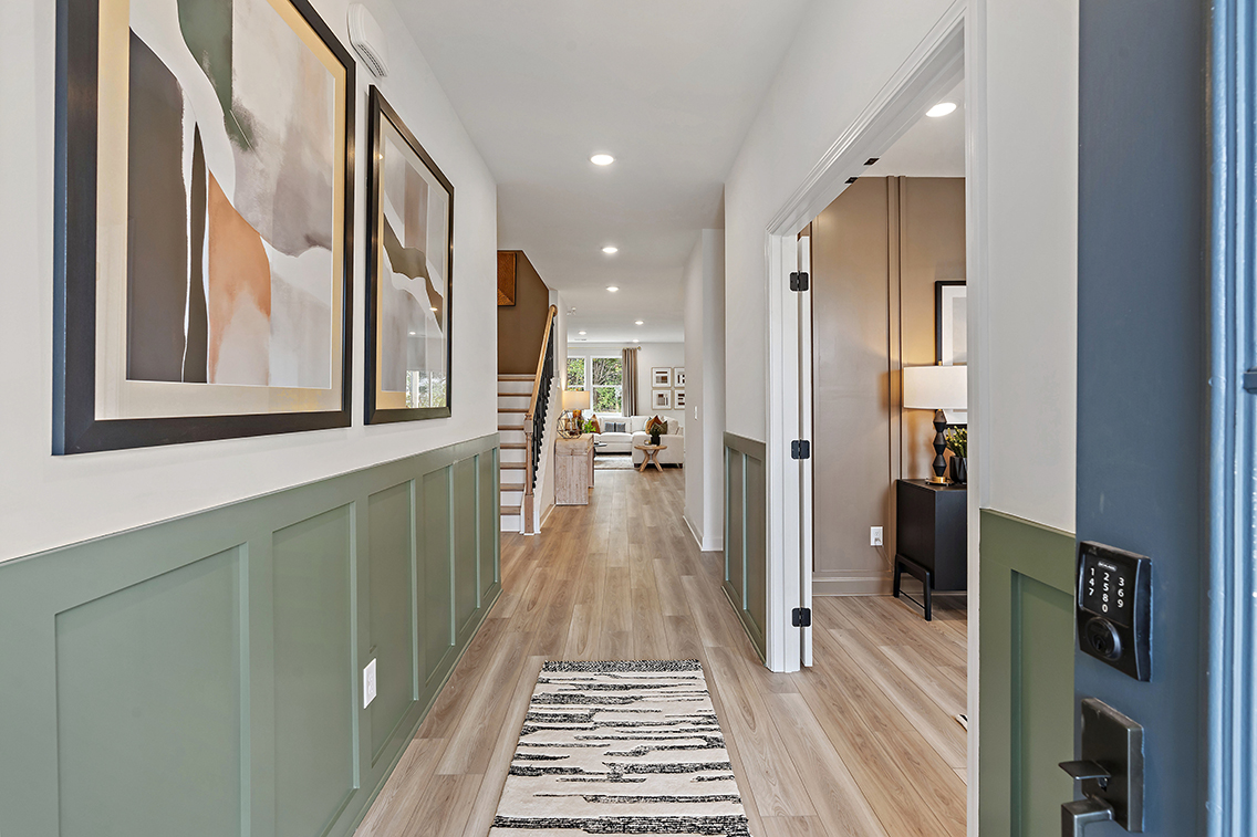 A long hallway with a wood floor.