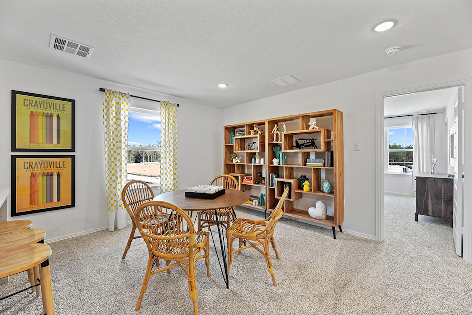 A room with a table and chairs.