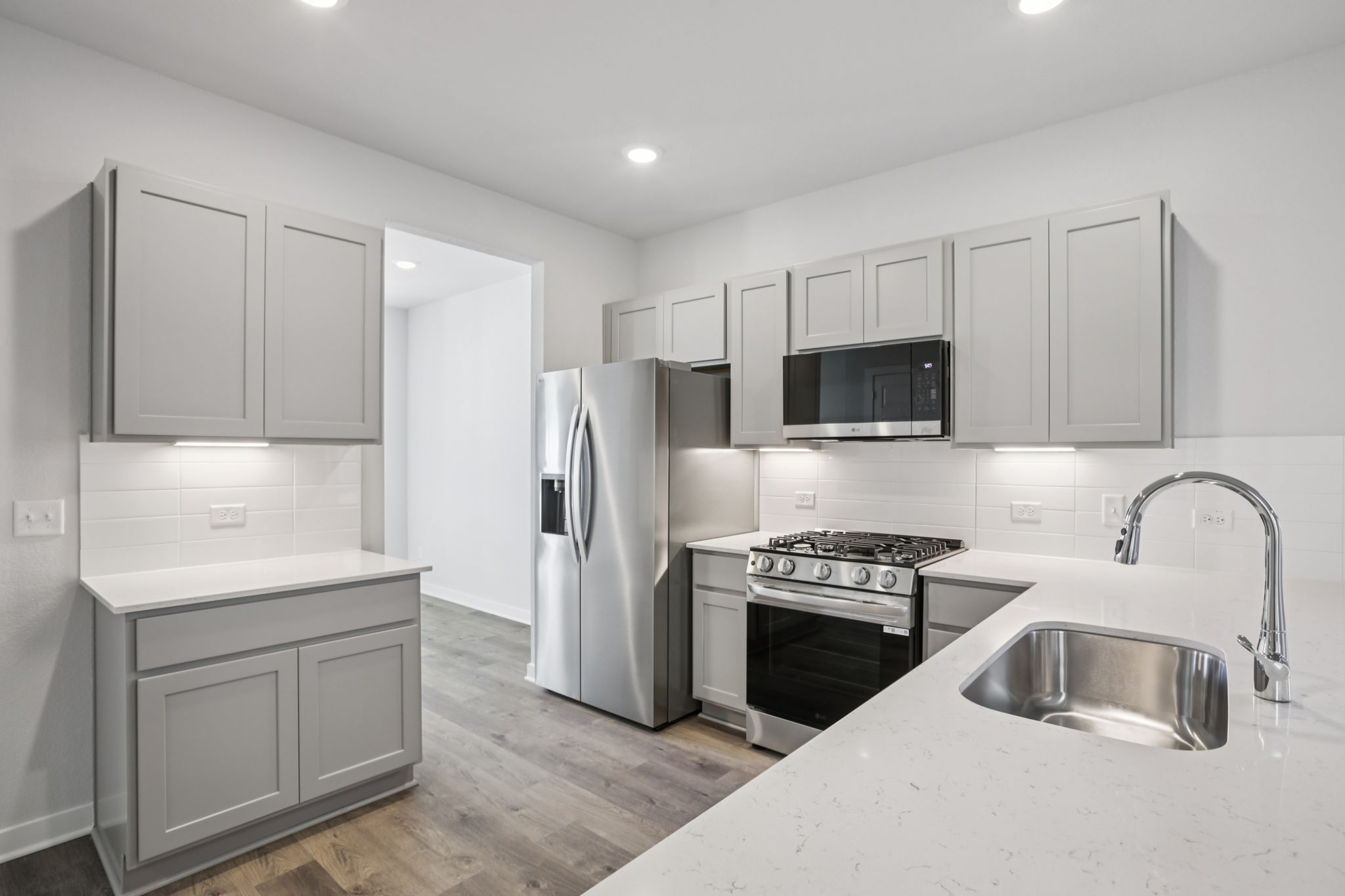 A kitchen with white cabinets.