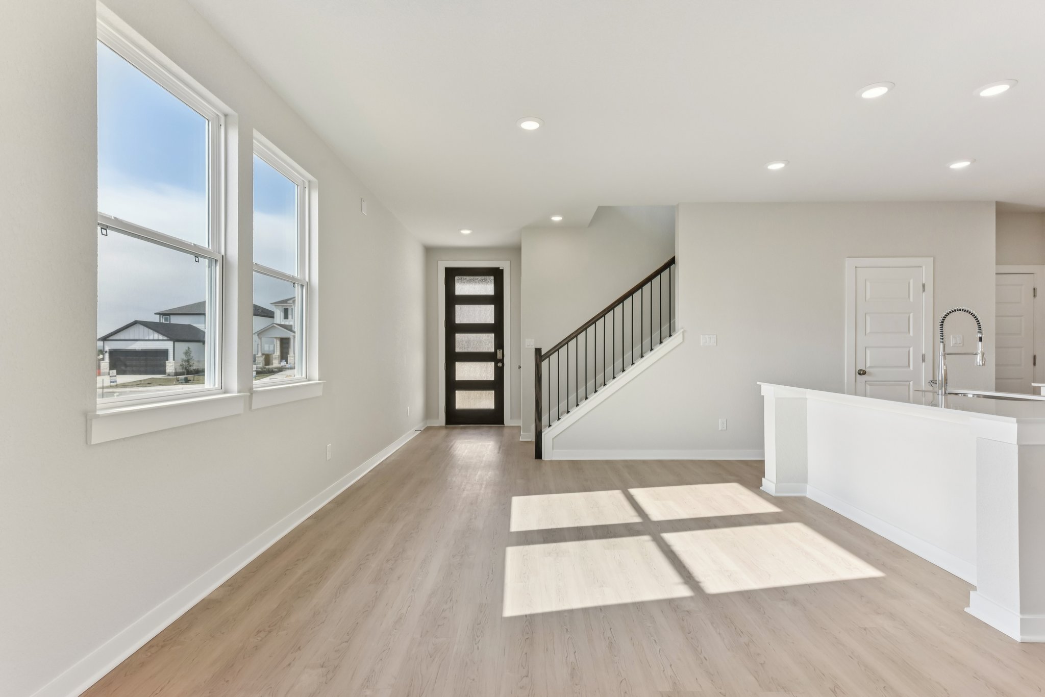A bathroom with a tub and a window.