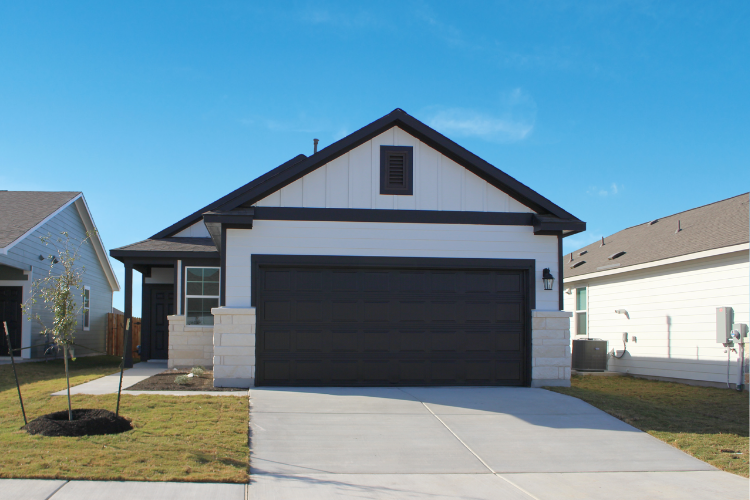 A house with a garage with American Gothic House in the background.