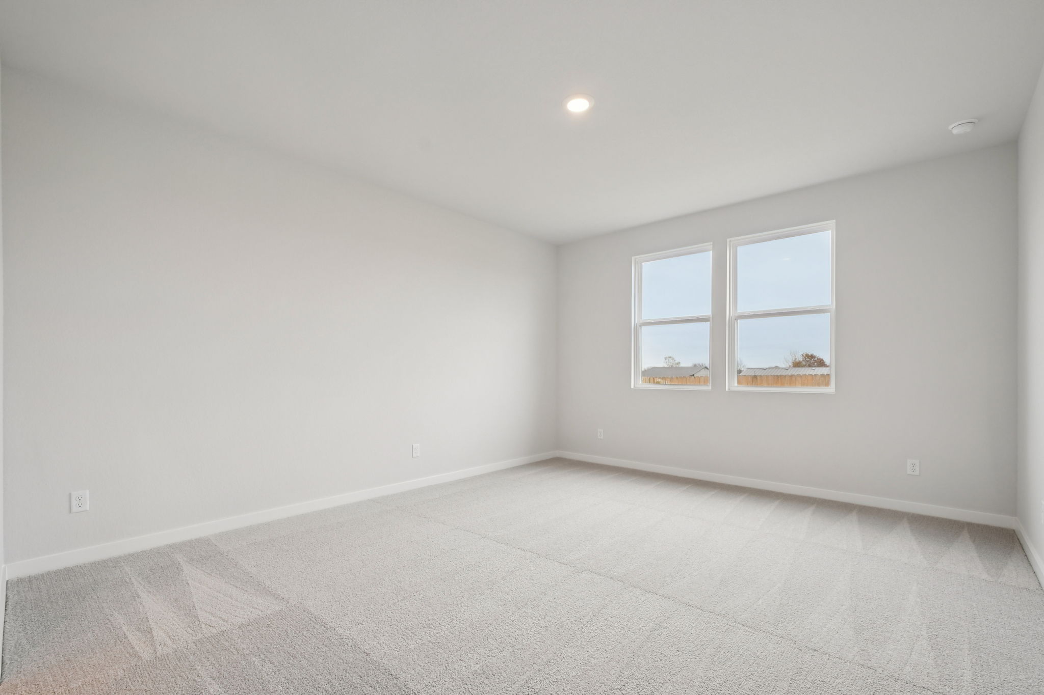 A room with a white floor and windows.