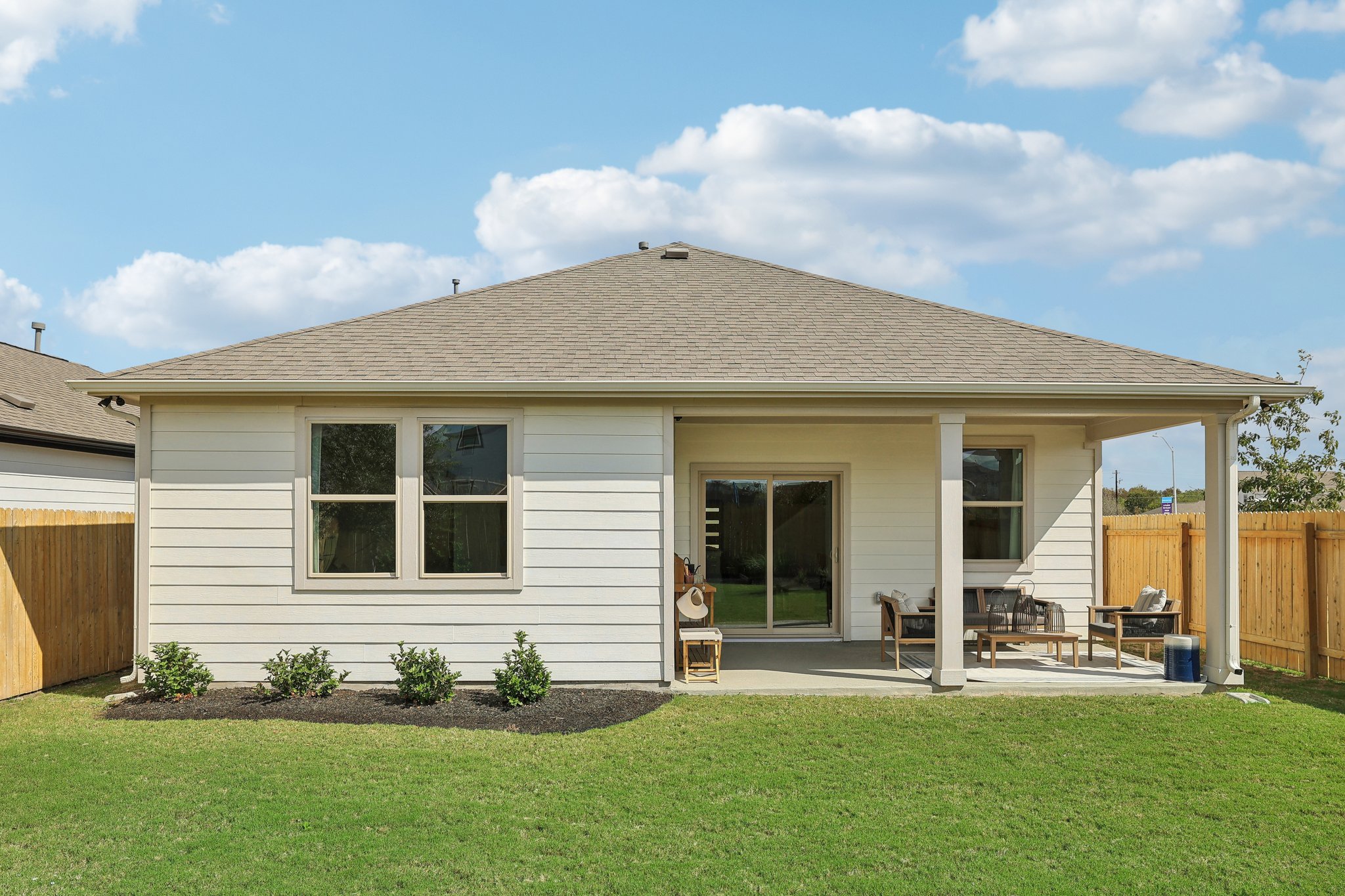 A person sitting in a chair outside a house.