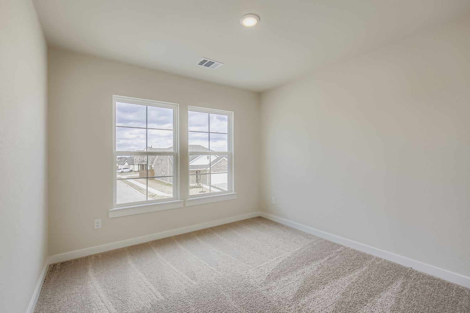 A room with a window and a carpet.