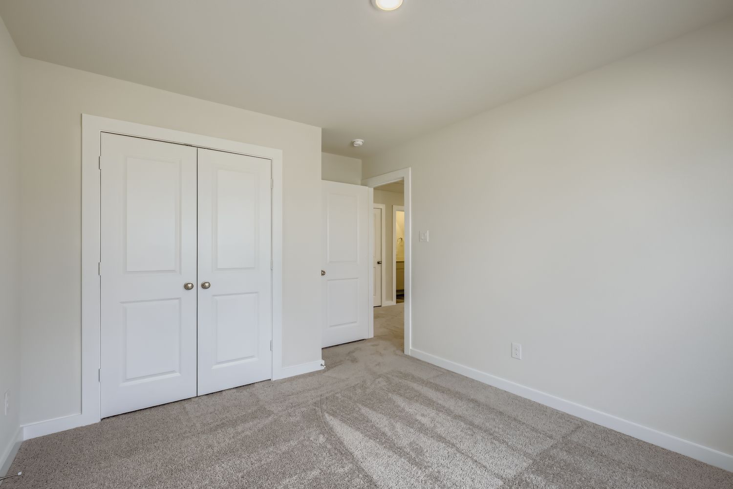 A hallway with white doors.