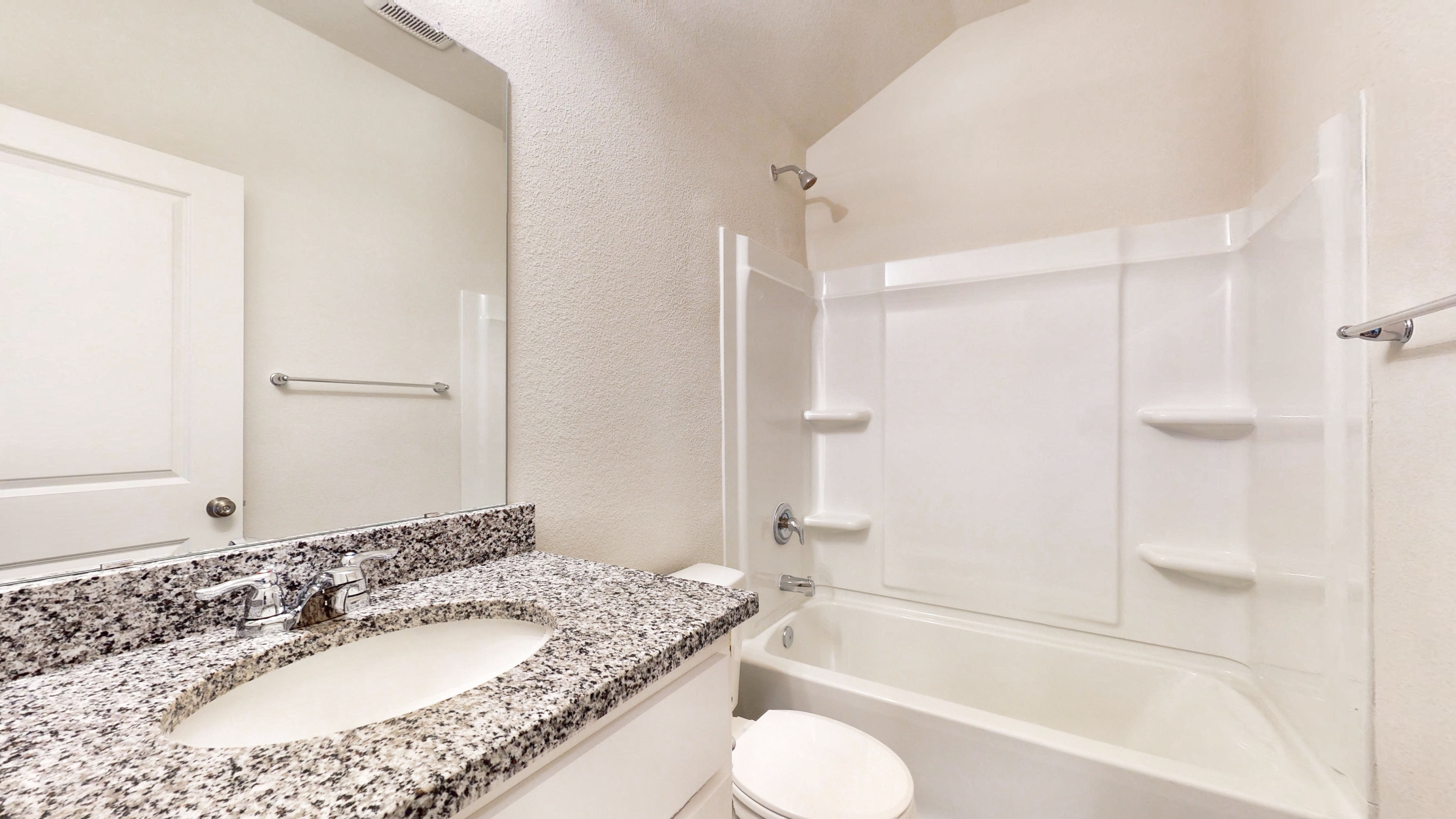 A bathroom with a marble countertop.