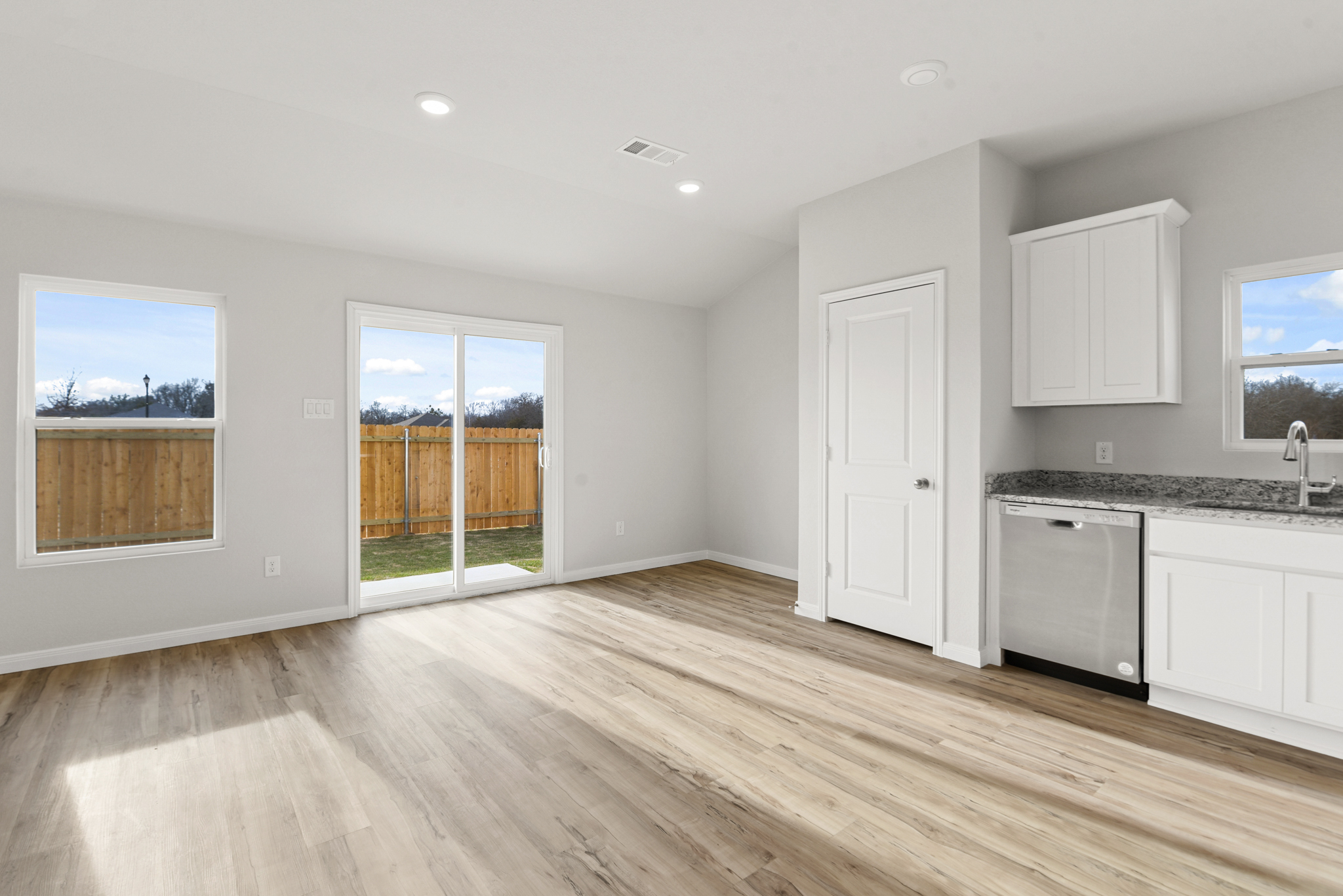 A kitchen with a wood floor.