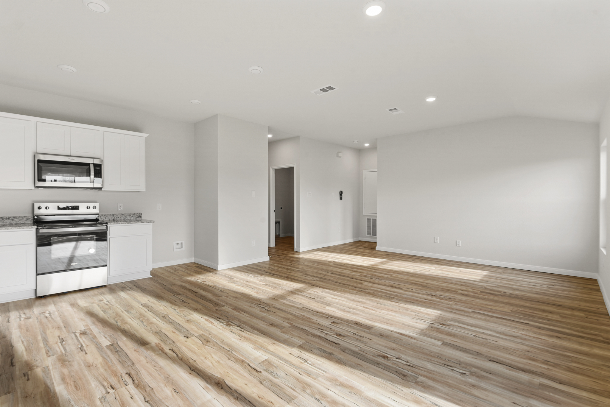 A large kitchen with white cabinets.