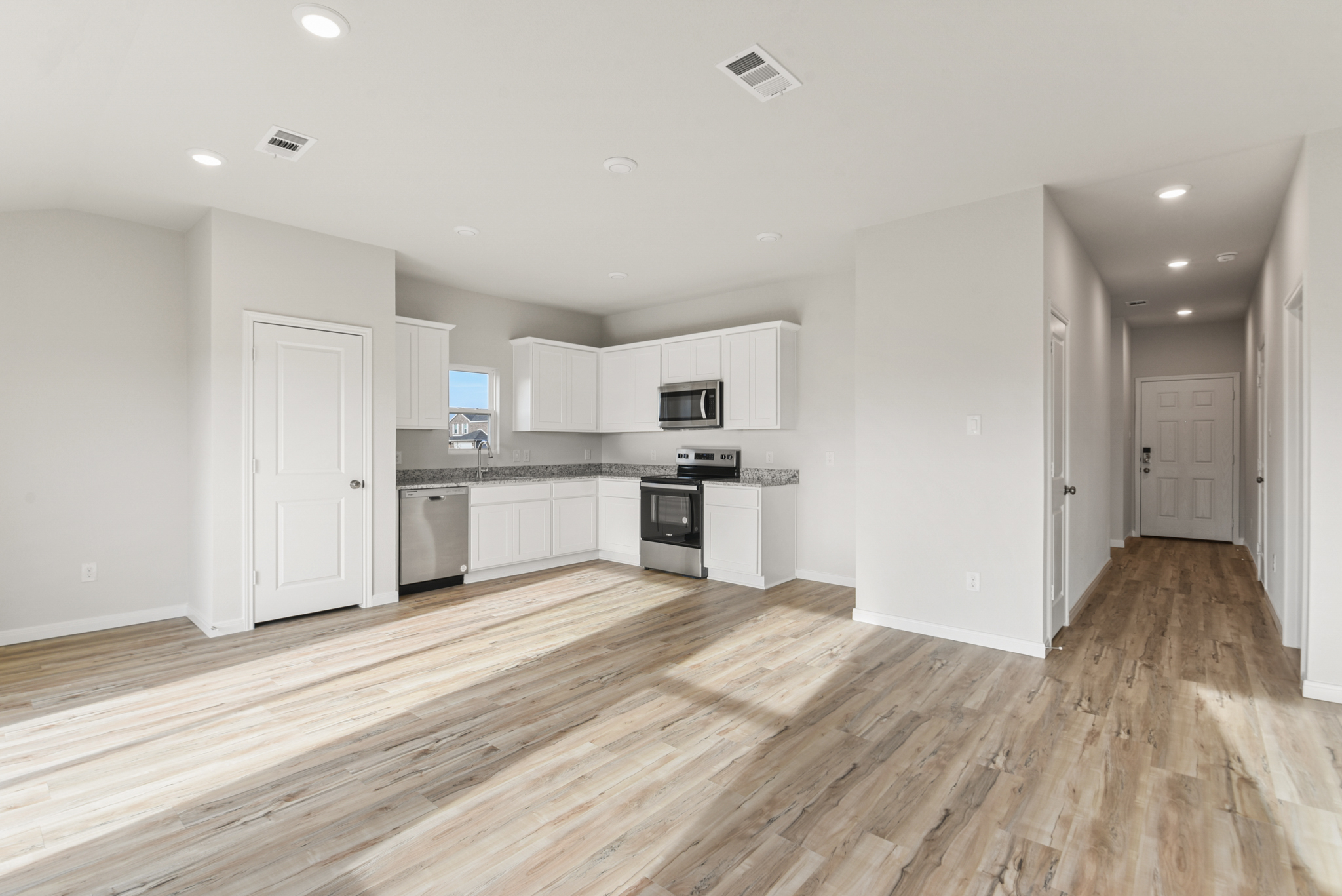 A kitchen with white cabinets.