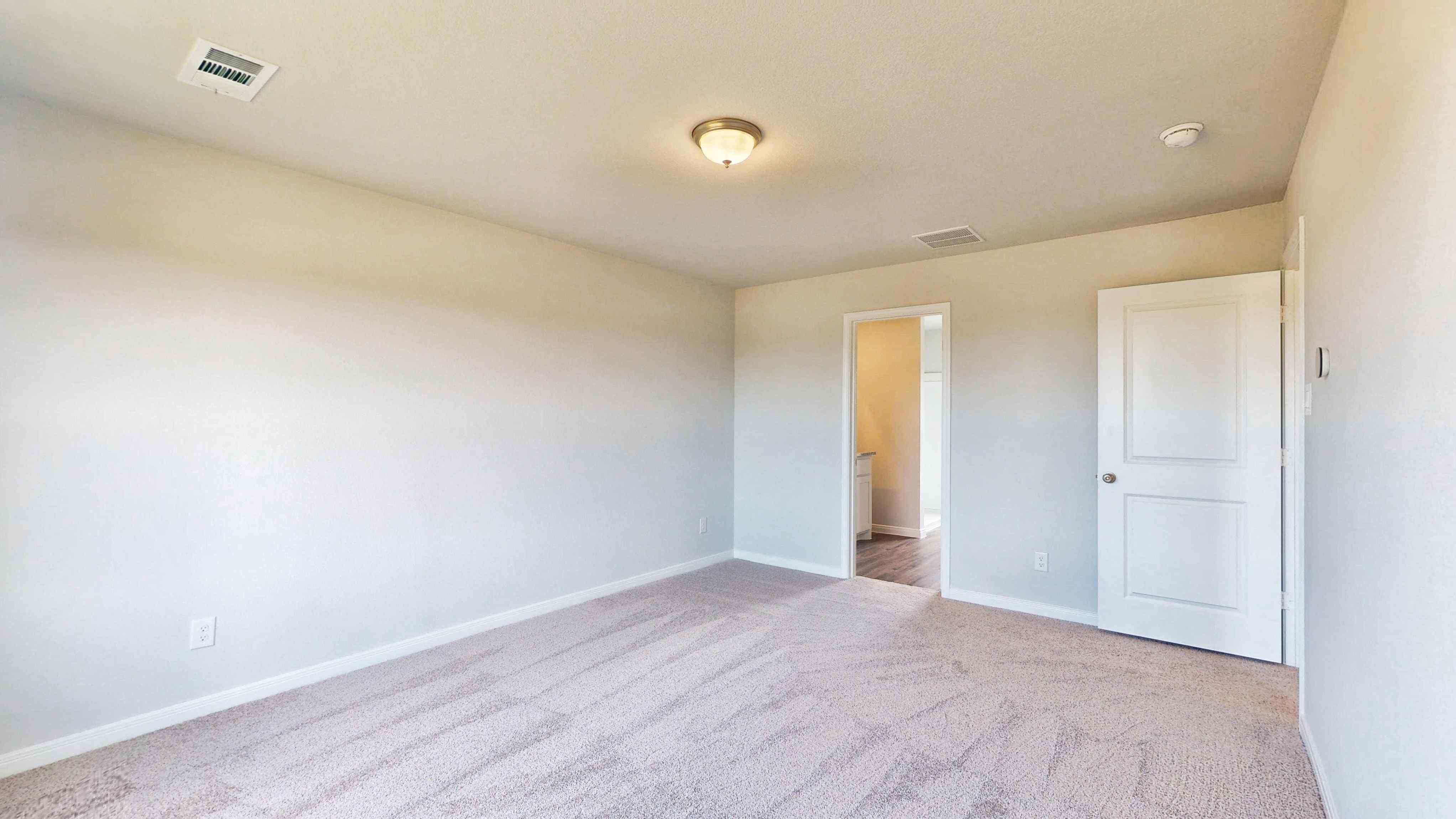 A hallway with white walls.