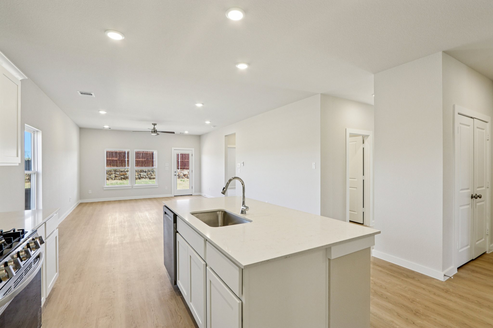 A kitchen with white cabinets.
