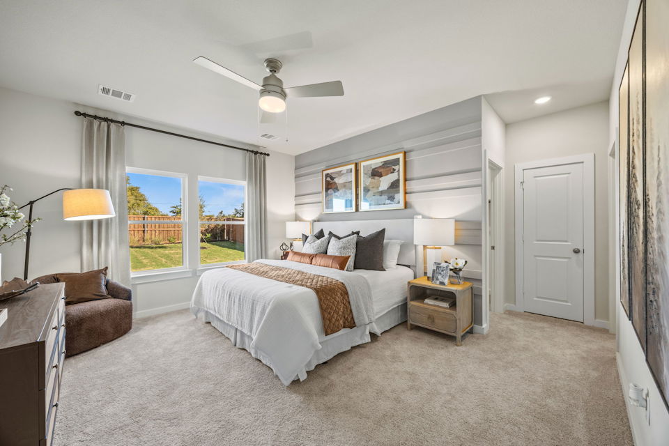 A bedroom with a large window.