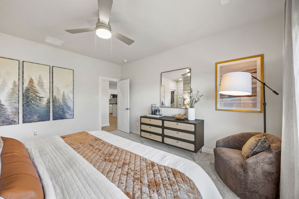 A bedroom with a bed and a couch.