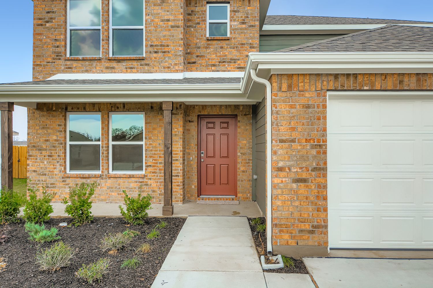 A brick house with a garage.